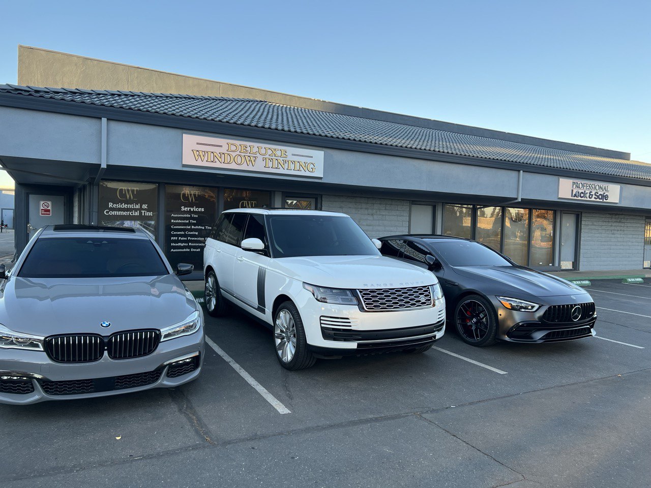 Luxury cars parked in front of Deluxe Window Tinting shop in Gold River, CA.